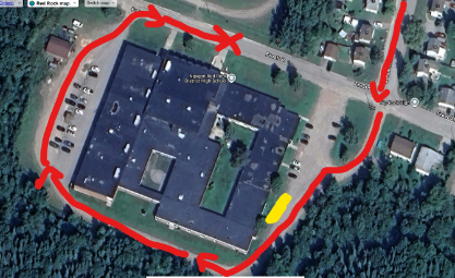 Bus parking map showing a red "x" where buses are to park, in front of the school entrance. It also shows where bus drivers should park - on the east side of the school, towards the back.